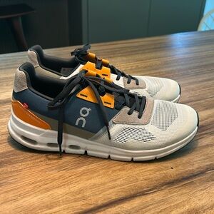 On Running Athletic Shoes in White, Orange, and Black